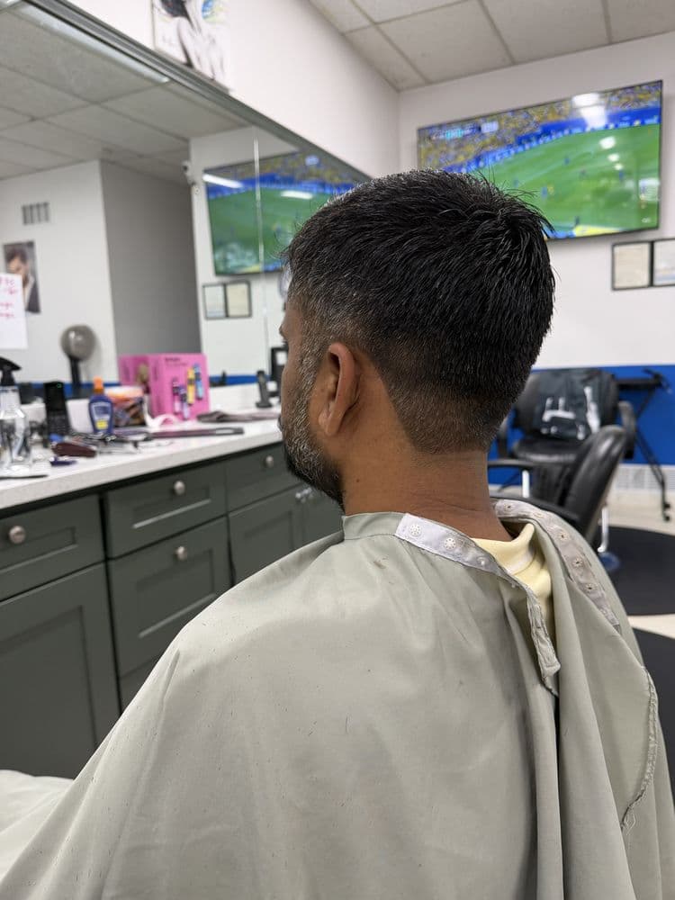 Men's classic taper haircut with a clean neckline at Dimension Hair Salon