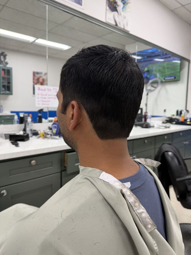 Men's dark short haircut with a tidy neckline at Dimension Hair Salon