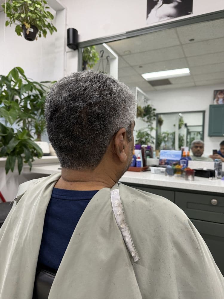 Men's short gray haircut with a natural finish at Dimension Hair Salon