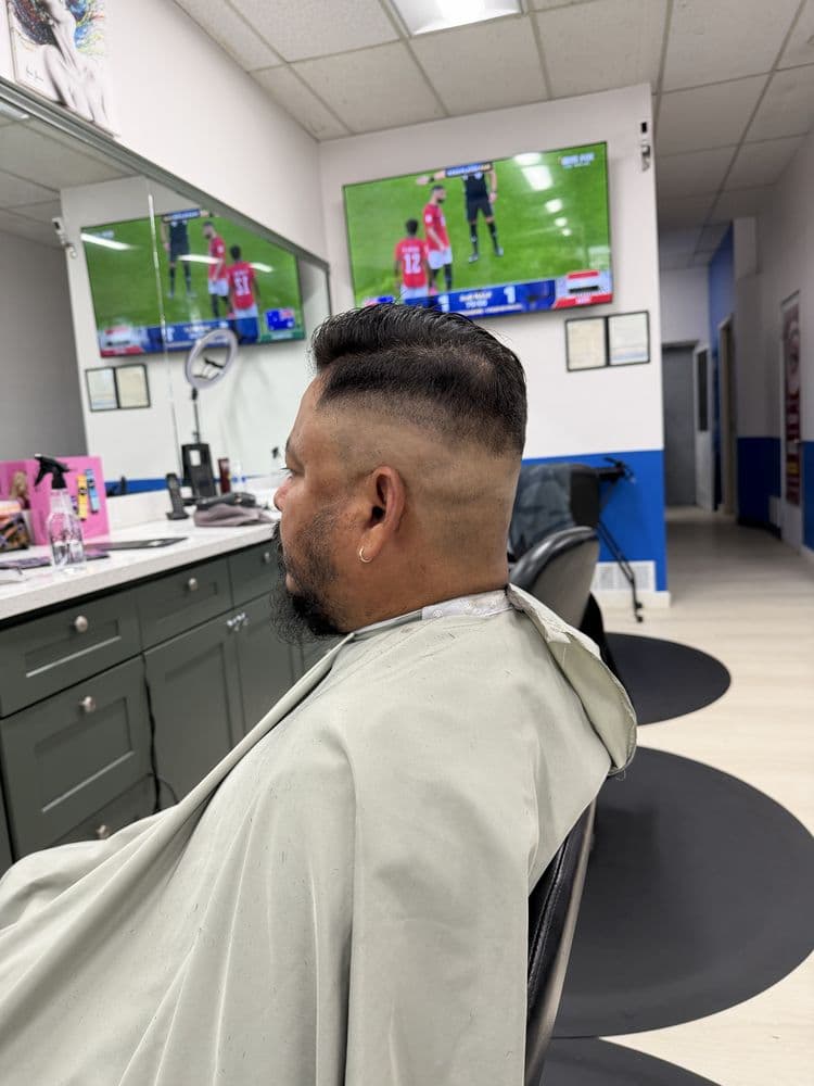 Men's high fade haircut with a styled top at Dimension Hair Salon in Bothell