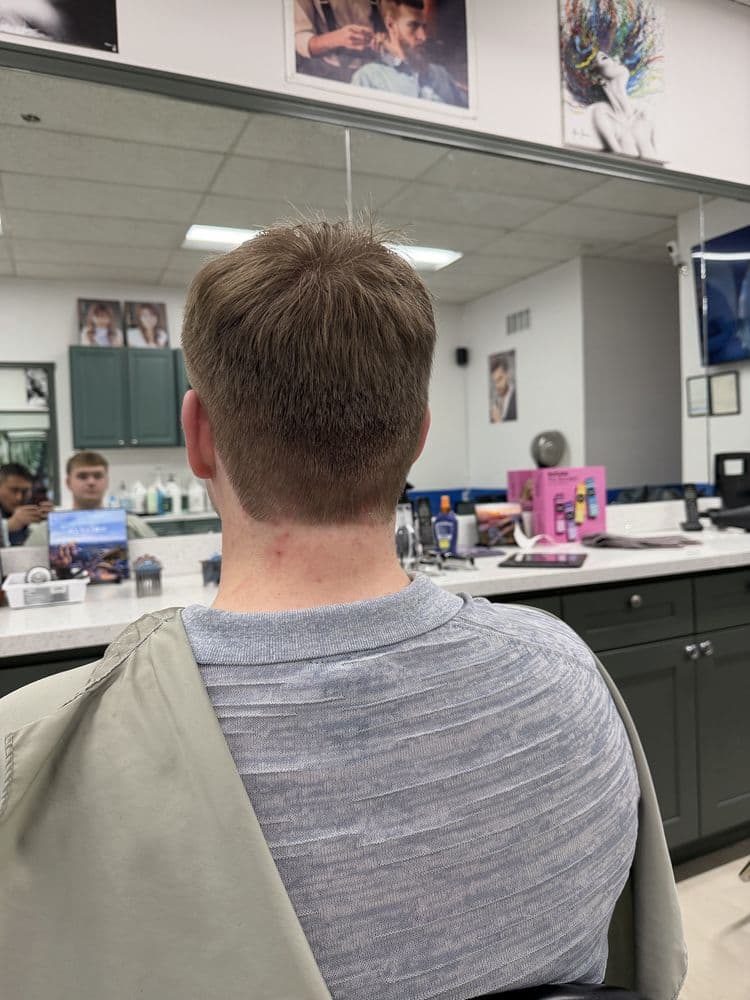 Back view of a men's light brown short haircut at Dimension Hair Salon