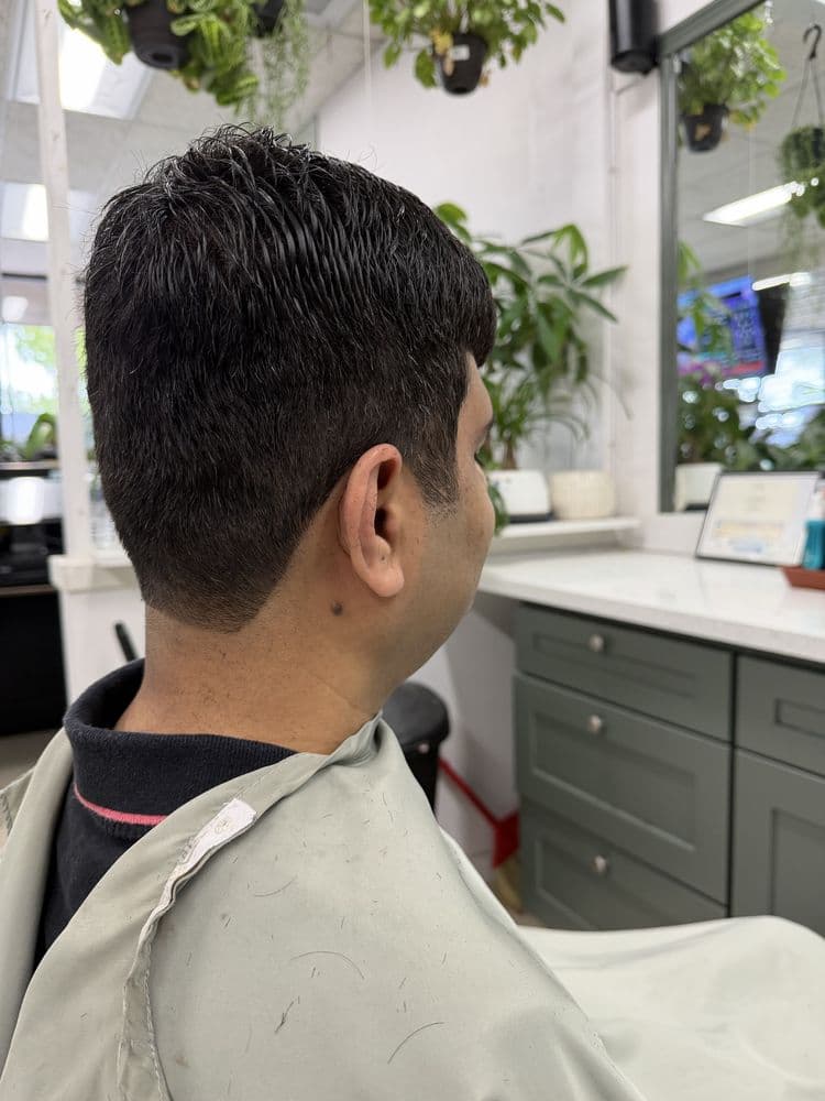 Men's short taper haircut photographed inside Dimension Hair Salon