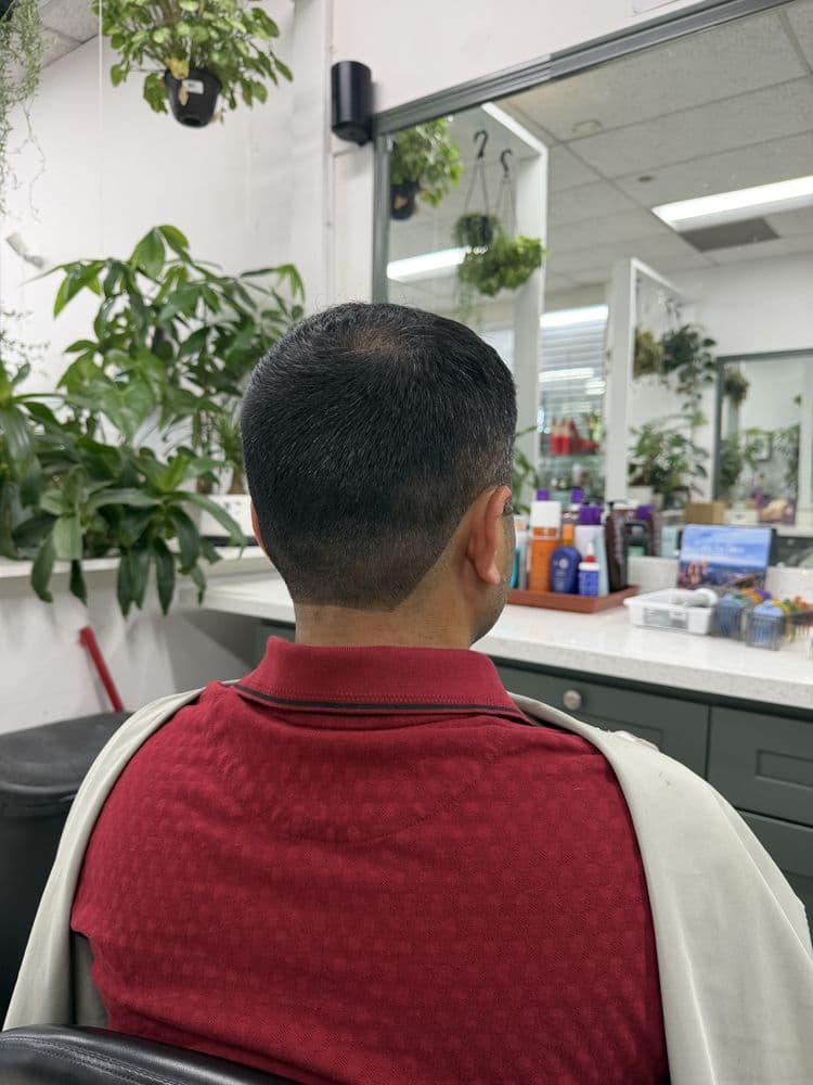Men's short taper haircut with a defined neckline at Dimension Hair Salon