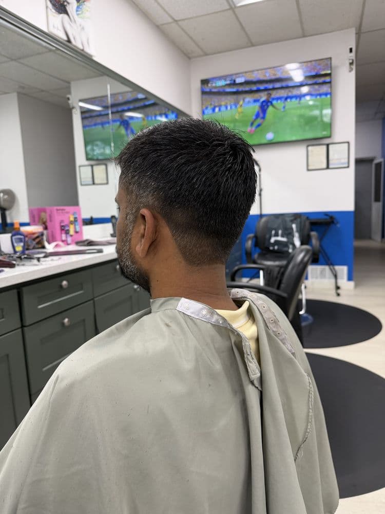 Men's short taper haircut viewed from the side at Dimension Hair Salon