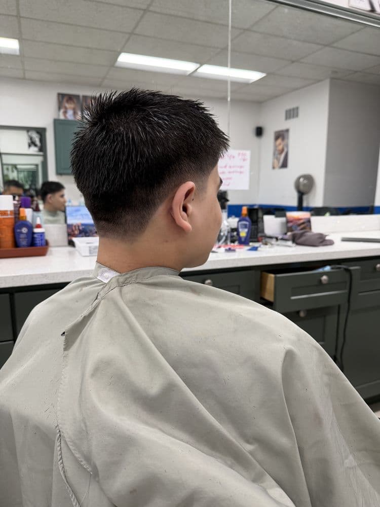 Men's textured crop haircut with a tapered back at Dimension Hair Salon