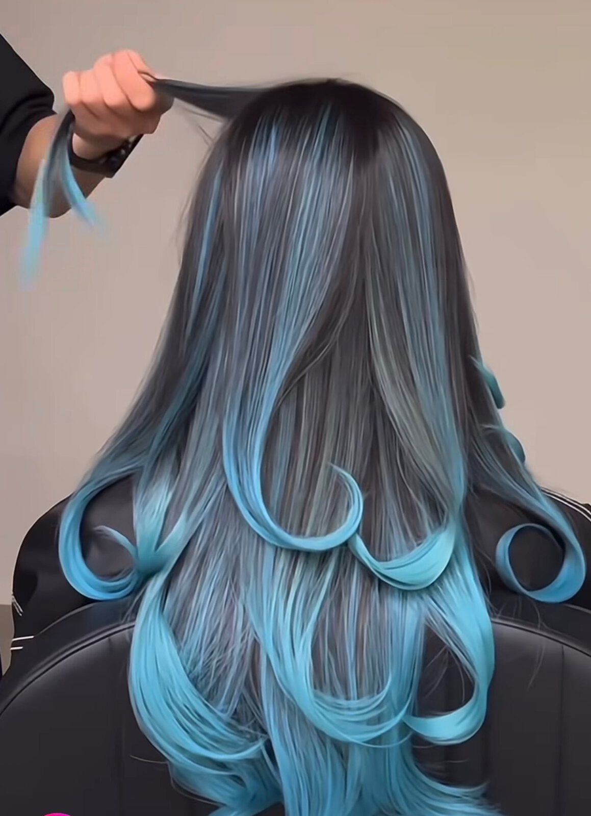 Vivid blue ombre hair color styled in curled sections