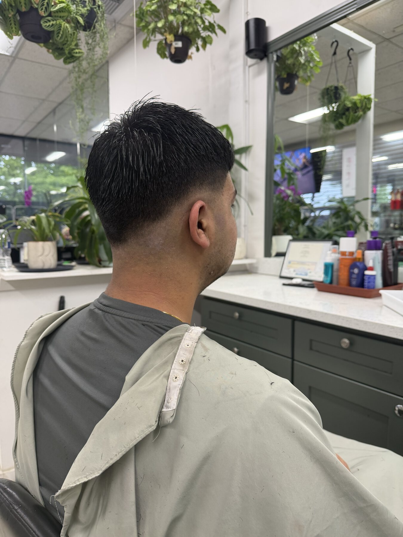 Men's curly taper haircut shown from the side
