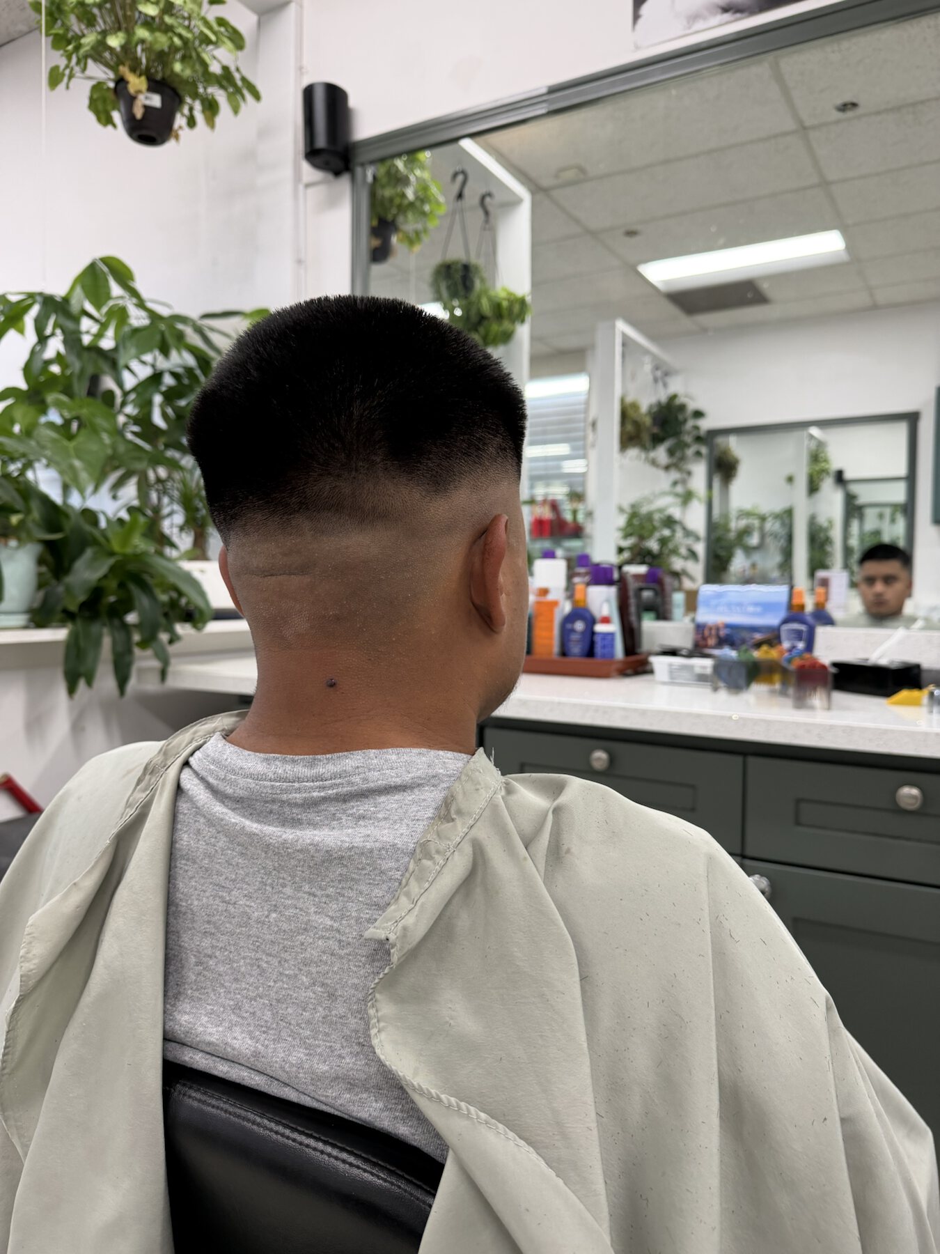 Back view of a high skin fade completed at Dimension Hair Salon