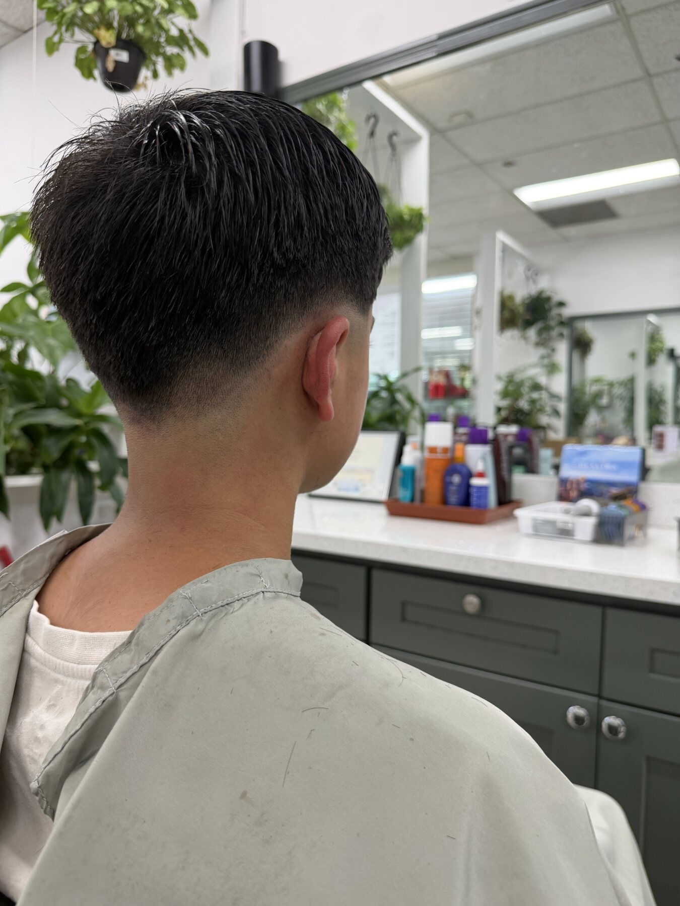 Men's low taper haircut photographed in the salon