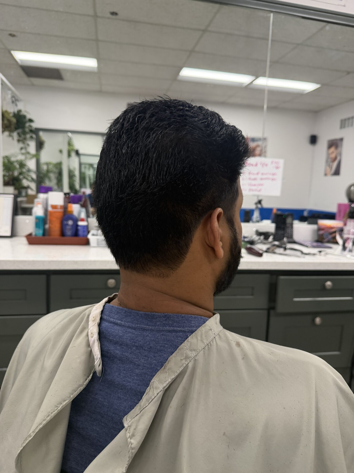 Men's textured taper haircut shown from the side